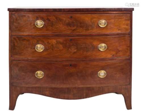 An early 19th Century mahogany bow-fronted chest:, containing three long drawers,