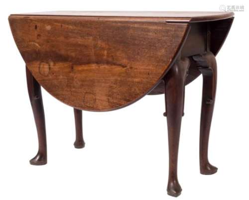 A mid 18th Century mahogany oval drop flap dining table:, with a hinged top on cabriole legs,