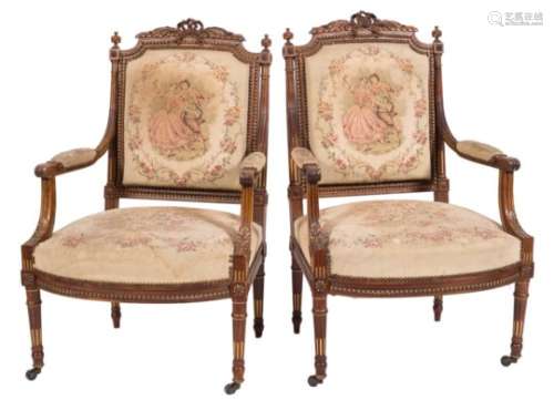 A pair of French carved beechwood and partly gilt fauteuils in the Louis XVI taste:,