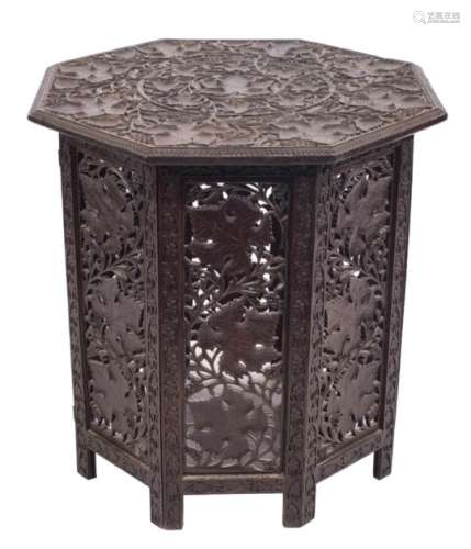 An Indian carved hardwood octagonal centre table,: on a hinged base,