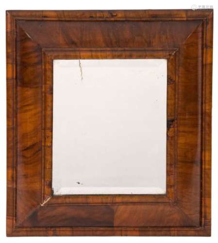 An 18th Century walnut cushion frame wall mirror:, with later inset rectangular bevelled plate,