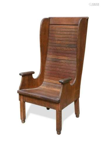 An early 20th century oak wing back arm chair,
