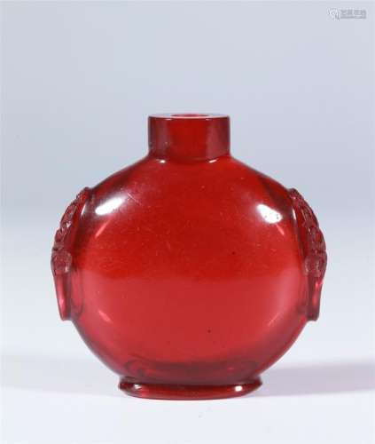 A CHINESE RUBY-RED GLASS SNUFF BOTTLE WITH MASKS