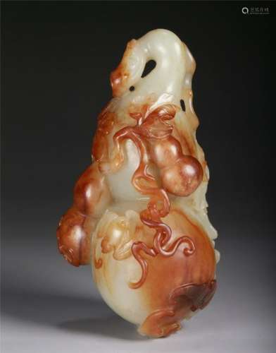 A CHINESE WHITE AND RUSSET JADE PENDANT