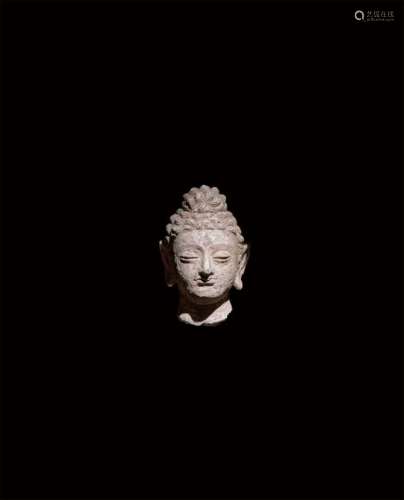 A STUCCO HEAD DEPICTING BUDDHA