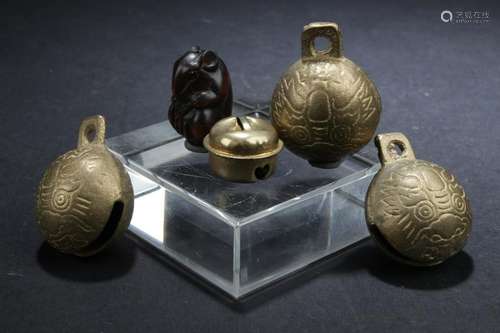 A Group of Four Bells and One Decorative Ornament