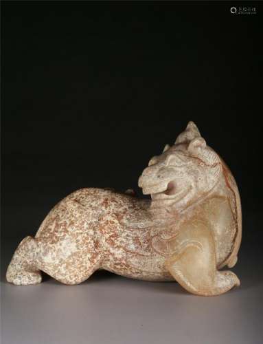 A CELADON AND RUSSET JADE CARVING OF A 'MYTHICAL BEAST'