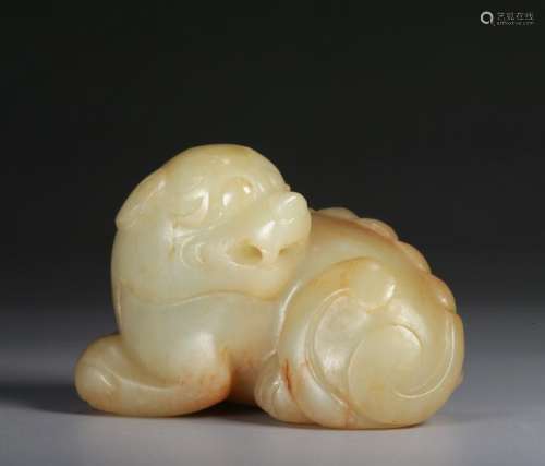 A WHITE AND RUSSET JADE CARVING OF A MYTHICAL BEAST