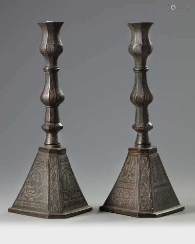 Two Persian bronze candle holders
