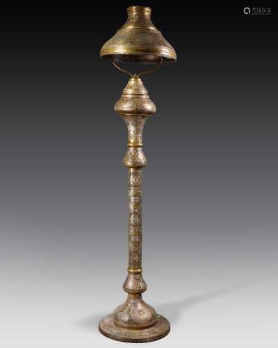 A large Islamic silver and copper inlaid lamp