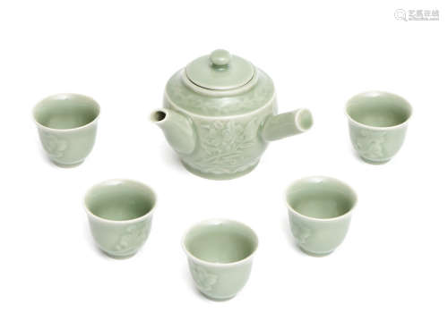 A Japanese Nabeshima-ware celadon sencha-tea set consisting of a tea pot (kyūsu)  with a perpendicular handle (yokote)