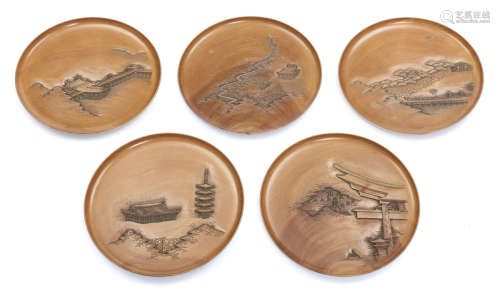 An exceptional Japanese set of five round plain hardwooden plates