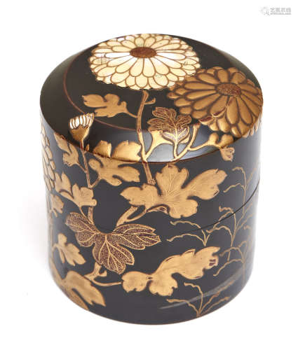 A Japanese black lacquered round tea caddy (natsume) decorated with chrysanthemum flowers