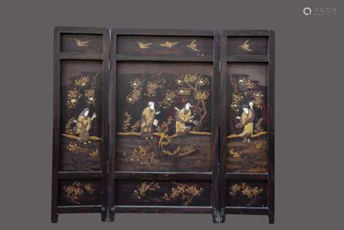 A Japanese wooden folding screen with ivory inlay