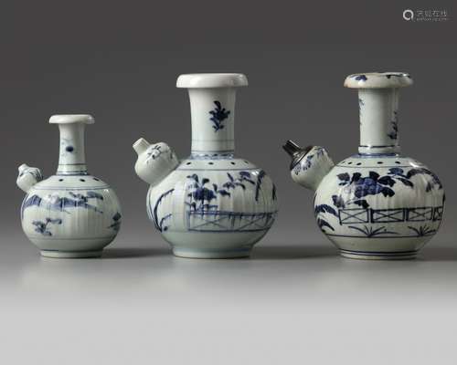 A group of three blue and white Arita kendi's