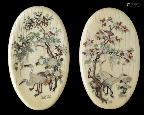 A pair of Japanese oval-shaped ivory mother-of-pearl inlaid 'cranes' plaques