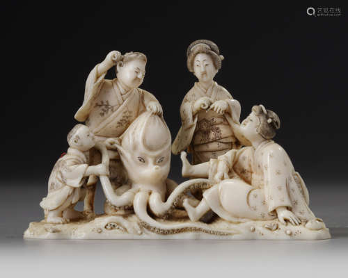 A Japanese ivory okimono of a group of four on the beach