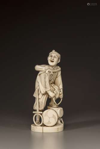 A Japanese ivory okimono of a man repairing his sandal