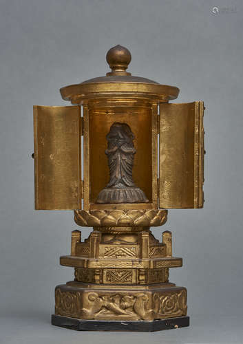 A small Japanese round gold-leaf lacquered zushi-shrine on a hexagonal stand