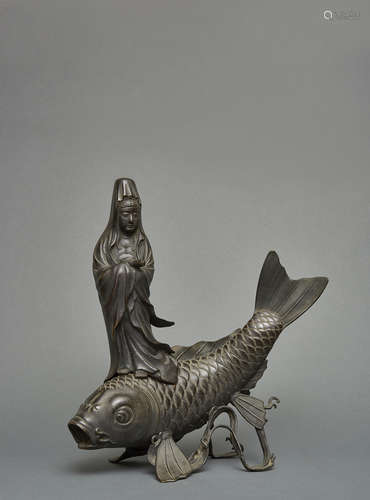 A Japanese bronze figure of bodhisattva Kannon standing on a large carp (koi)