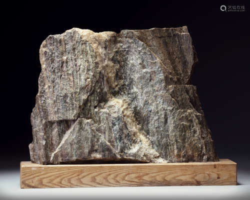 A Japanese Suiseki (Aesthetic) natural stone on a wooden base