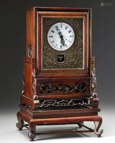 A Chinese gilt bronze table clock in a hongmu case and stand