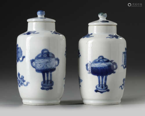 A pair of small Chinese blue and white vases and covers