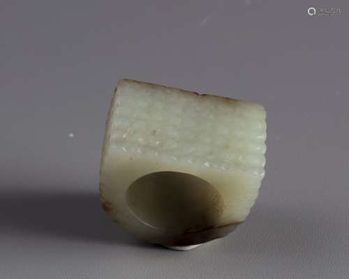 A Chinese white and russet jade archers ring