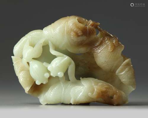 A large Chinese celadon and russet jade ‘lotus and gold fish’ carving