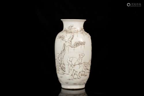 A CARVED WHITE- GLAZED BOTTLE VASE