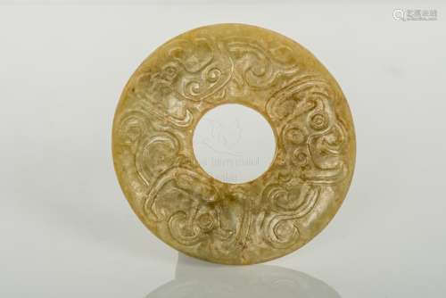 AN OLIVE-GREEN AND RUSSET JADE HUAN DISC