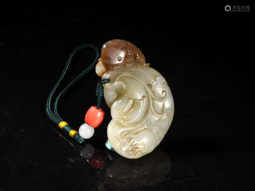 A CREAMY WHITE AND BROWN JADE CARVING