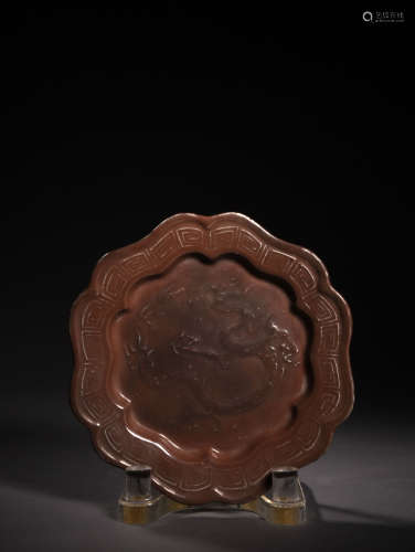 A COPPER-RED LOBED PLATE, POSSIBLY 14TH CENTURY