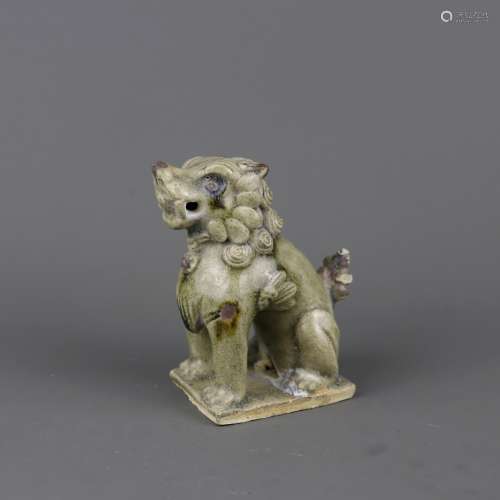 A Chinese Celadon Glazed Porcelain Foo-Dog
