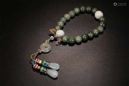 A Chinese Carved Jadeite Bracelet