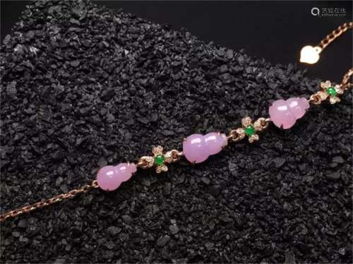 A Chinese Carved Pink Jadeite Bracelet