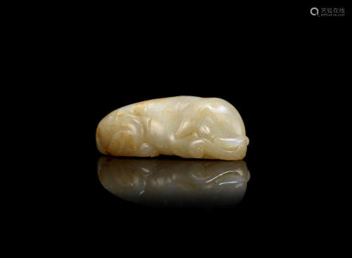 A pale green jade carving of a recumbent elephant