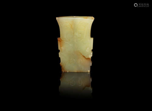 A pale green and russet jade archaistic pendant