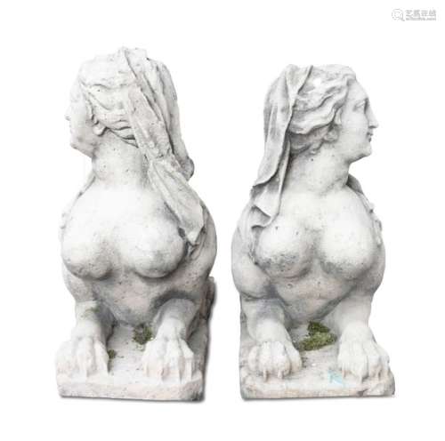 A PAIR OF CARVED STONE SPHINXES, each depicted wit…