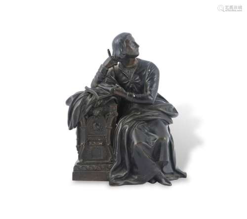 A CAST BRONZE FIGURE OF A SEATED SCRIBE. 20cm tall