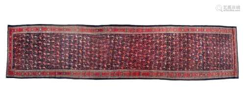 A WOOL RUNNER, LATE 20TH CENTURY, the central fiel…
