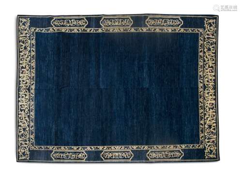 A LARGE SEMI ANTIQUE NAVY GROUND WOOL RUG, the pla…
