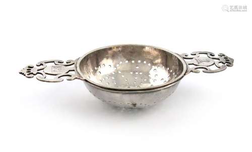 A George I silver two handled lemon strainer, by J…