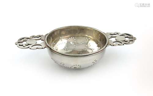 A George I silver two handled lemon strainer, by W…