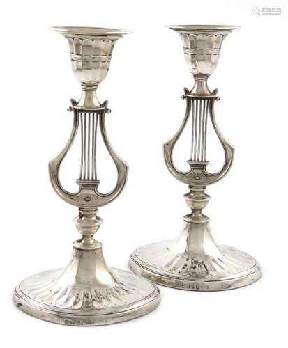 A pair of late Victorian silver lyre candlesticks,…
