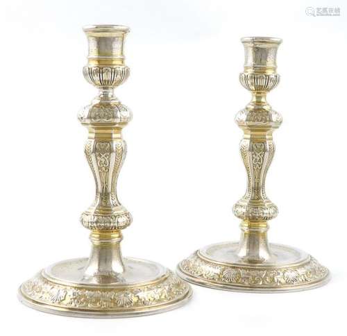 A pair of Queen Anne silver gilt candlesticks, by …