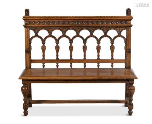 A 19TH CENTURY CARVED OAK HALL BENCH, the rectangu…