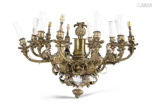 A CAST BRASS TWELVE BRANCH CEILING LIGHT, the pine…