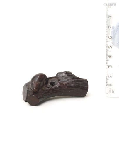 By Seiyodo Gansui (1809-1848), first half of the 19th century A kurogaki (black persimmon) wood netsuke of a rat on a branch