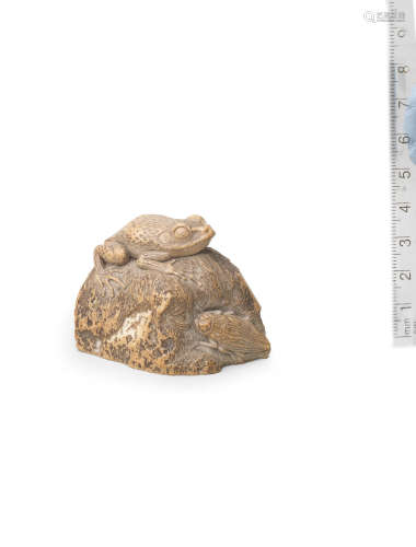 Attributed to Tsuramitsu (Kanman, 1793-1859), Iwami Province, early 19th century A stone carving of a frog and beetle on a rock